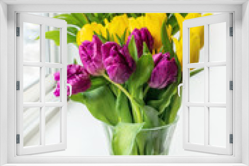 Fototapeta Naklejka Na Ścianę Okno 3D - A beautiful bouquet of colorful spring tulips stands on the window. Close-up