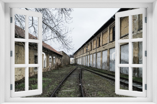 Fototapeta Naklejka Na Ścianę Okno 3D - old unused railway line between two huts