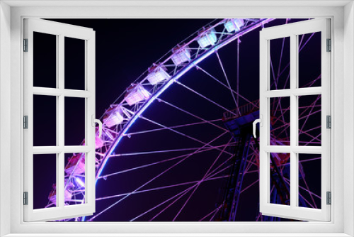 Fototapeta Naklejka Na Ścianę Okno 3D - Part of ferris wheel with purple lighting at night