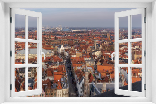 Fototapeta Naklejka Na Ścianę Okno 3D - Fantastic Bruges city skyline with red tiled roofs and numerous churches' towers in sunny winter day. View to Bruges medieval cityscape from the top of the Belfry Tower.