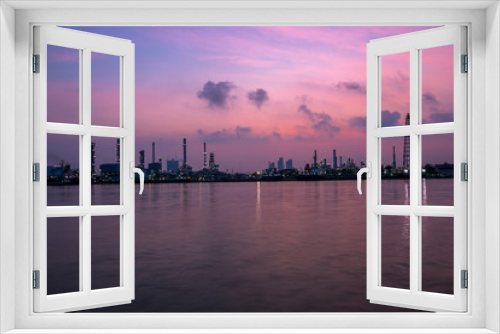 Fototapeta Naklejka Na Ścianę Okno 3D - The blurred background of nature along the river, with views of the cargo ship, oil refinery, sunrise and beautiful sky in the morning