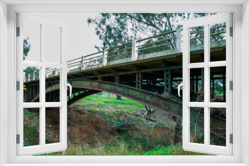 Fototapeta Naklejka Na Ścianę Okno 3D - Old rusty bridge over dry riverbed
