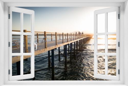 Fototapeta Naklejka Na Ścianę Okno 3D - Beautiful view from the wooden pier or bridge on calm ocean sea waves and sunset over the mountains