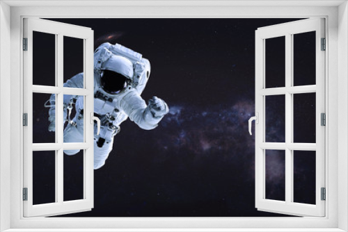 Fototapeta Naklejka Na Ścianę Okno 3D - Alone single Astronaut in outer space. Science fiction wallpaper. Elements of this image were furnished by NASA.