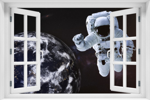 Fototapeta Naklejka Na Ścianę Okno 3D - Astronaut in outer space with Earth planet of solar system. Science fiction wallpaper. Elements of this image were furnished by NASA