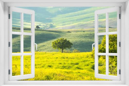Fototapeta Naklejka Na Ścianę Okno 3D - Val d'Orcia landscape in spring. Hills of Tuscany. Cypresses, hills, yellow rapeseed fields and green meadows. Val d'Orcia, Siena, Tuscany, Italy - May, 2019.