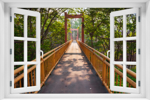 Fototapeta Naklejka Na Ścianę Okno 3D - Yellow steel bridge pathway in to forest