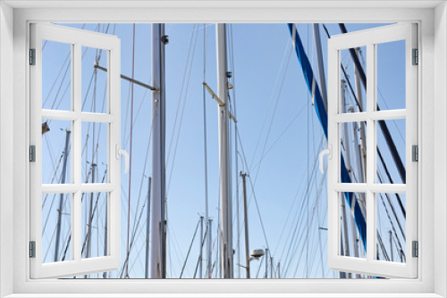 Fototapeta Naklejka Na Ścianę Okno 3D - Sailing masts in the marina in a sunny da