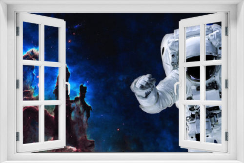 Fototapeta Naklejka Na Ścianę Okno 3D - Space astronaut near pillars of creation. Space adventure in outer space. Science fiction. Elements of this image were furnished by NASA 