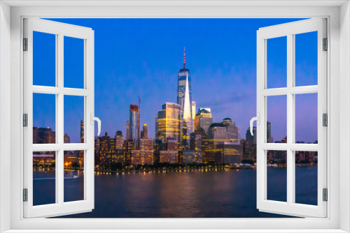 Fototapeta Naklejka Na Ścianę Okno 3D - New York City Skyline with Skyscrapers Illuminated at Dusk