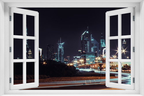 Fototapeta Naklejka Na Ścianę Okno 3D - Night landscape with views of the skyscrapers and the Burj Khalifa from the side of the road
