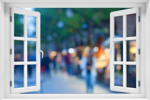 Defocused image of the street summer food festival in the evening