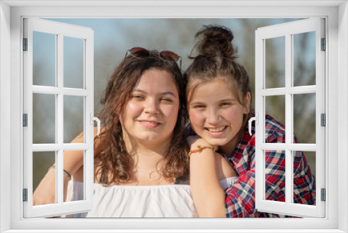 portrait of two happy sisters, outdoors