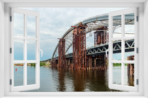 Fototapeta Naklejka Na Ścianę Okno 3D - Large bridge under construction across the Dnieper River in Kiev Ukraine