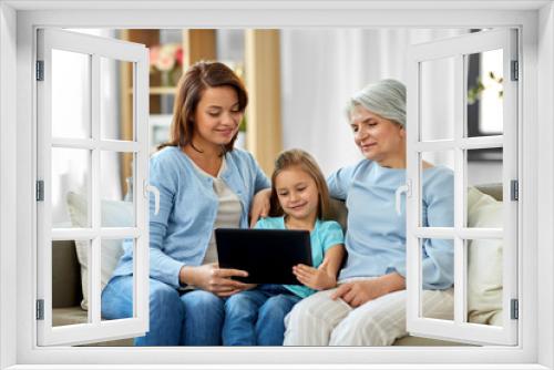 family, generation and technology concept - happy mother, daughter and grandmother with tablet computer at home