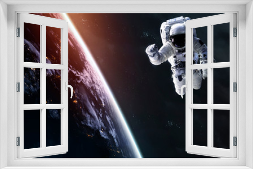 Fototapeta Naklejka Na Ścianę Okno 3D - Astronaut at the Earth planet orbit. Awesome science fiction render. Elements of this image furnished by NASA