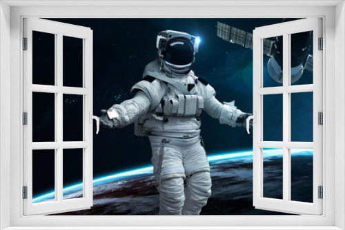 Fototapeta Naklejka Na Ścianę Okno 3D - Astronaut at Earth orbit. Science fiction wallpaper. Elements of this image furnished by NASA