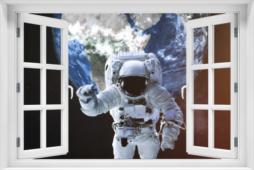 Fototapeta Naklejka Na Ścianę Okno 3D - Astronaut in a front of Earth planet of solar system with lens flare. Science fiction. Elements of the image were furnished by NASA