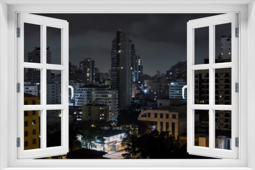 Fototapeta Naklejka Na Ścianę Okno 3D - Buildings of Sao Paulo city at a cloudy night. Urban photo of the city during night.