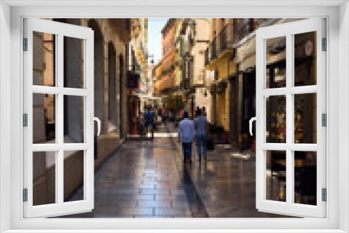 Fototapeta Naklejka Na Ścianę Okno 3D - Pedestrians walking down Navas street to shops and restaurants in Granada Spain