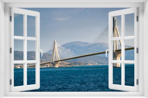 Fototapeta Naklejka Na Ścianę Okno 3D - The Rio Antirrio Bridge, is one of the world's longest multi-span cable-stayed bridges and longest of the fully suspended type. It crosses the Gulf of Corinth over the deep blue sea near Patras.