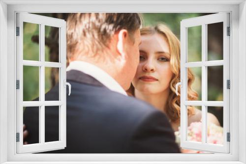 bride and groom kiss on the background of trees and forest