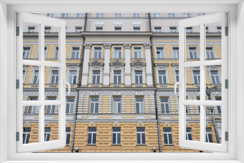 Fototapeta Naklejka Na Ścianę Okno 3D - Several Windows in a row on the facade of the old building. Windows in a row on a marble wall. Rows of Windows on a tall building.