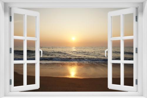 Fototapeta Naklejka Na Ścianę Okno 3D - Southern tropical summer ocean coast at sunset. Lagoon with waves in which the sun is reflected.