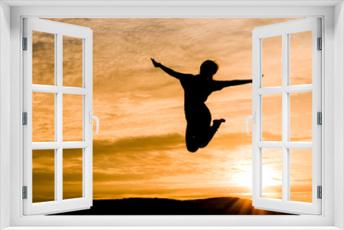 Fototapeta Naklejka Na Ścianę Okno 3D - Silhouette of woman jumping