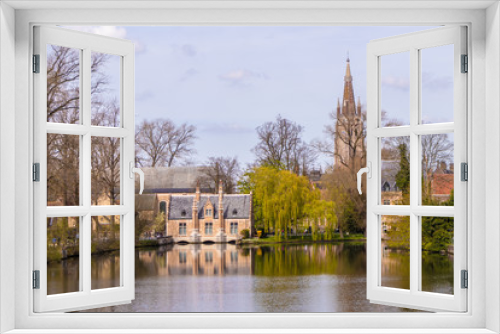 Fototapeta Naklejka Na Ścianę Okno 3D - Bruges, Belgium - APRIL 05, 2019: Minnewater lake and medieval castle in Bruges