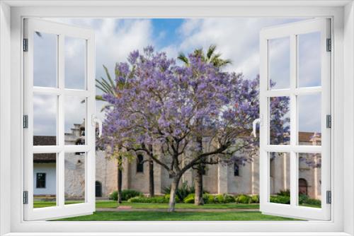 Fototapeta Naklejka Na Ścianę Okno 3D - Beautiful Jacaranda Trees blossom and Mission Church