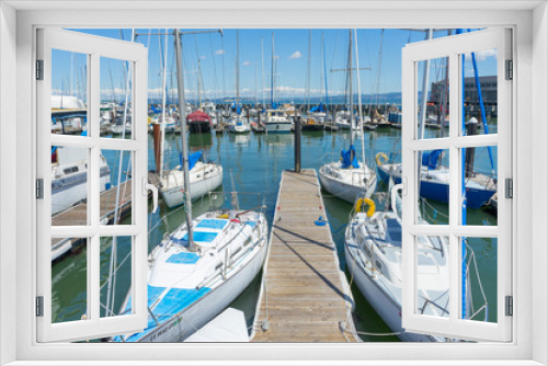 Fototapeta Naklejka Na Ścianę Okno 3D - Sunny Day View of Pier 39 Marina with yachts and boats docking in San Francisco,CA