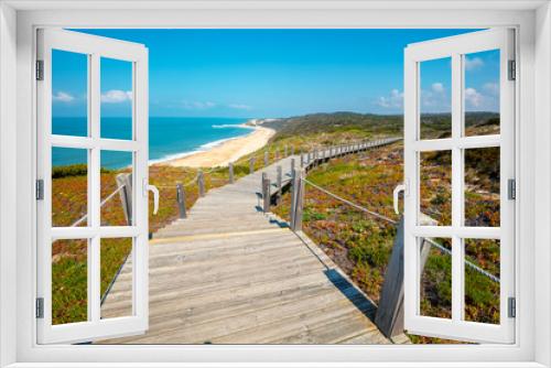 Fototapeta Naklejka Na Ścianę Okno 3D - The wooden stairway at the rocky seashore on a sunny day. Polvoeira the beach. Pataias, Portugal, Europe