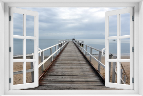 Fototapeta Naklejka Na Ścianę Okno 3D - Great views of Hervey Bay from the wooden Torquay jetty. The pier is also a popular fishing spot at all tides. Gushing sea on a cloudy day. Horizontal view of dramatic overcast sky and sea.