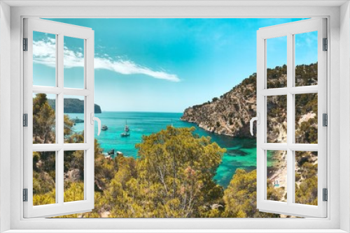 Fototapeta Naklejka Na Ścianę Okno 3D - View from above of the beautiful Cala Blanca, Andratx with a turquoise waters  and spanish nature landscape with blue bright summer sky. Mallorca, Balearic Islands