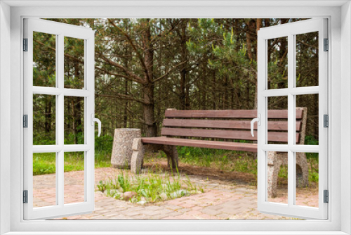 Fototapeta Naklejka Na Ścianę Okno 3D - Wooden park bench at a park. A place to rest.