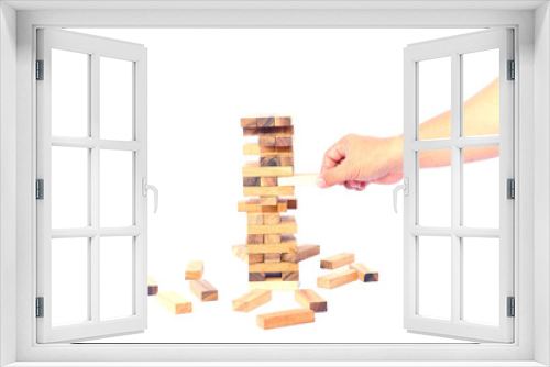 Fototapeta Naklejka Na Ścianę Okno 3D - hand of businessman pulling out or placing wood block on the tower in modern office. plan and strategy in business. blur for background