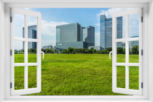 Fototapeta Naklejka Na Ścianę Okno 3D - beautiful green meadow near modern office building.