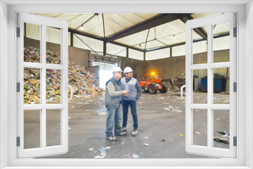 full length view of two men in recycling center