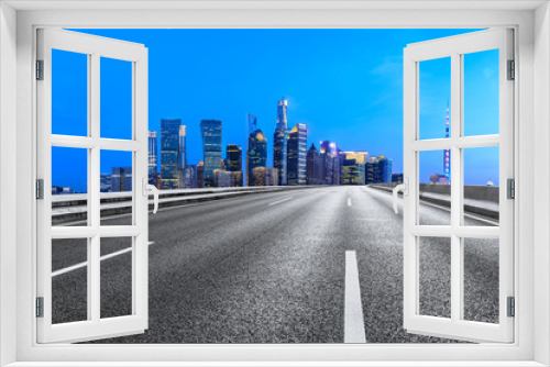 Fototapeta Naklejka Na Ścianę Okno 3D - Shanghai modern commercial buildings and empty asphalt road at night