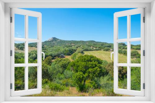 Fototapeta Naklejka Na Ścianę Okno 3D - Scenic landscape of green hills and rocky mountains of the island of Sardinia in spring