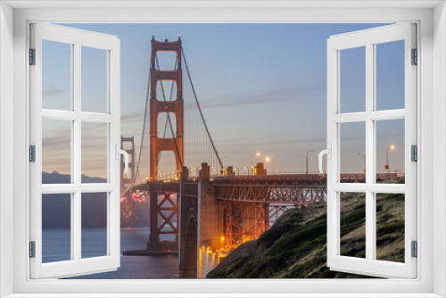 Fototapeta Naklejka Na Ścianę Okno 3D - Twilight colors of the Golden Gate Bridge as seen from above Marshall's Beach. San Francisco, California, USA.