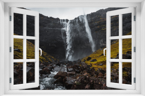 Fototapeta Naklejka Na Ścianę Okno 3D - Fossa, the largest waterfall on the Faroe Islands, as seen during early spring with snow-covered mountain peaks and lush greens (Faroe Islands, Denmark, Europe) 