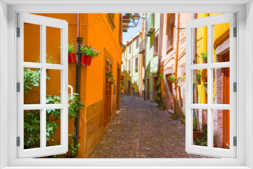 Fototapeta Naklejka Na Ścianę Okno 3D - Colorful houses in the alleys of the town of Bosa in Sardinia in sunlight in spring