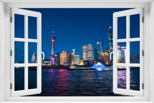 Fototapeta Naklejka Na Ścianę Okno 3D - Shanghai, China - JUN 21 , 2018 :Nightscape of Lujiazui skyline as seen from the Bund, across the Huangpu. Zoom to across the night view. Night panorama of beautiful Shanghai city with bright lights,