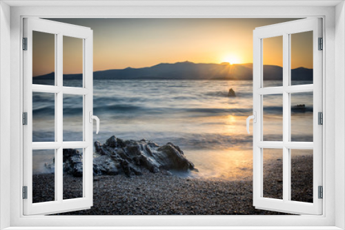 Fototapeta Naklejka Na Ścianę Okno 3D - Sunrise on Antiparos island, rock and beach in the foreground, Paros island in the background. Cyclades Greece