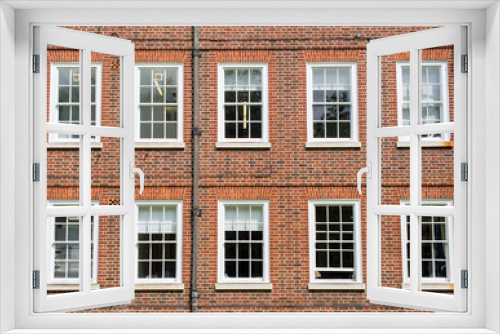Fototapeta Naklejka Na Ścianę Okno 3D - Eight windows with white sash and frame on a red brick wall Georgian British style