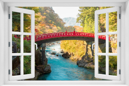 Fototapeta Naklejka Na Ścianę Okno 3D - Shinkyo red bridge, landmark of Nikko the world heritage site of Japan. Wonderful scenic view with warm sun shade and turquoise blue water.