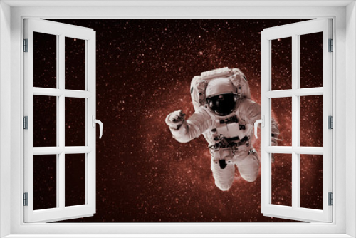 Fototapeta Naklejka Na Ścianę Okno 3D - astronaut flies over the earth in space. Violet color. 