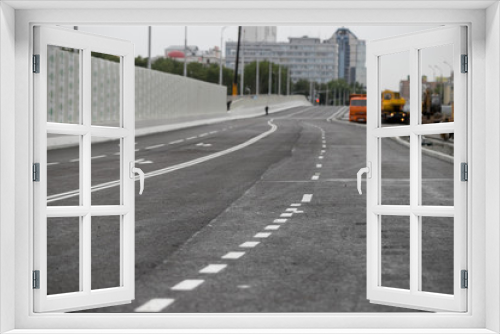 Fototapeta Naklejka Na Ścianę Okno 3D - The texture of gray asphalt road. White markings on the track. Road trip. Big wide road.